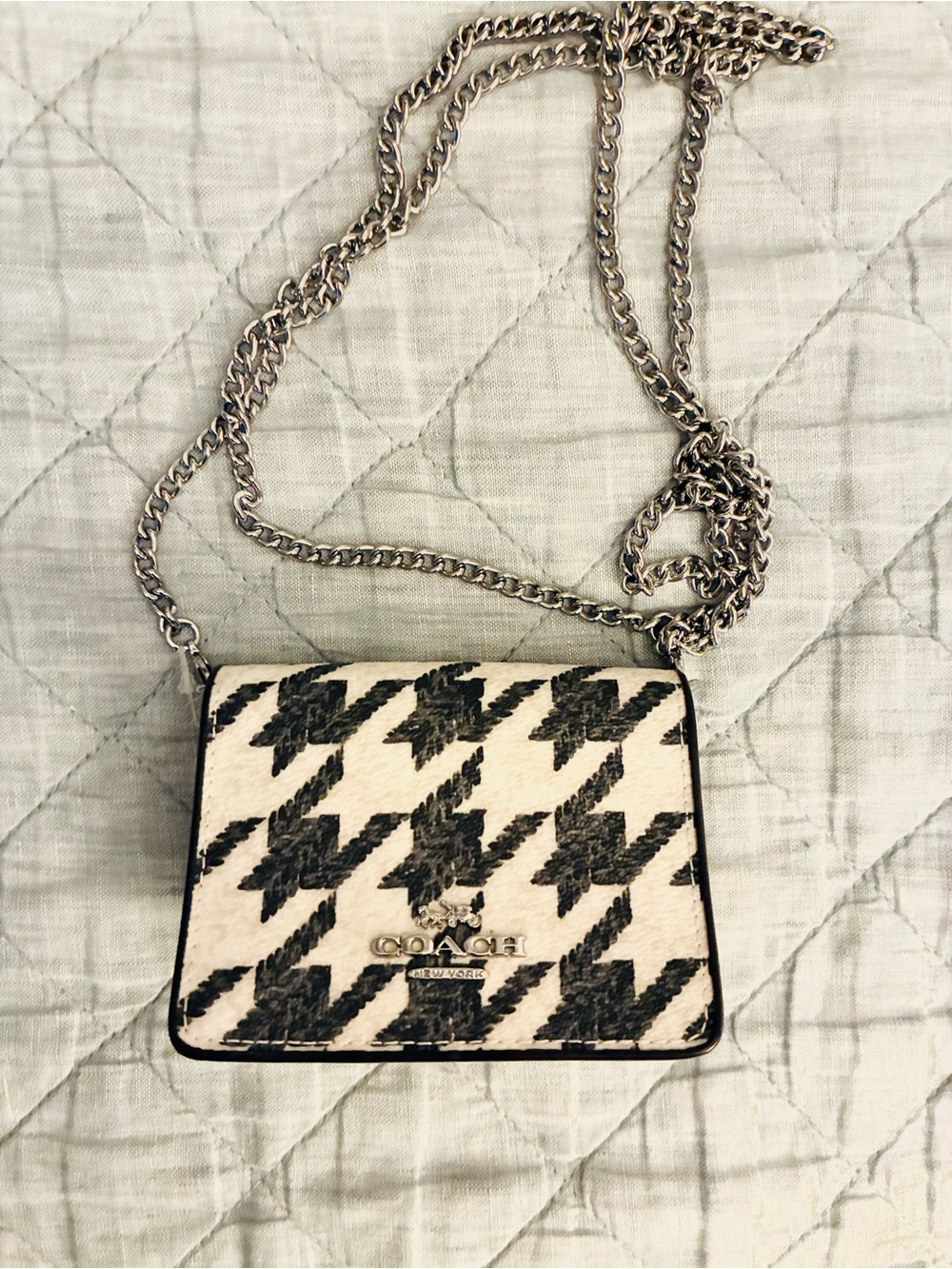 Coach mini wallet on silver chain black and cream houndstooth pattern. Crossbody